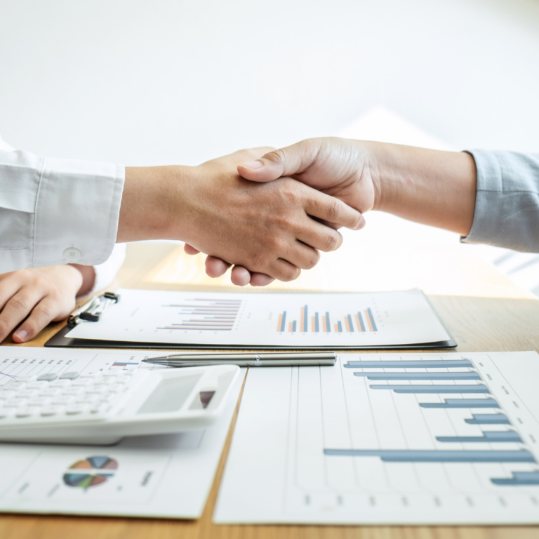 Handshake between two people at desk