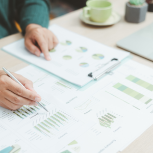 Hand pointing to business metrics.